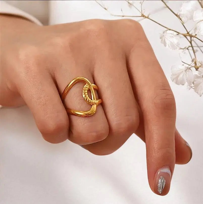 Eleganter Twist Charm Ring aus goldfarbenem Metall mit kunstvollem, verdrehtem Design. Perfektes Schmuckstück für individuellen Stil und Ausdruck.