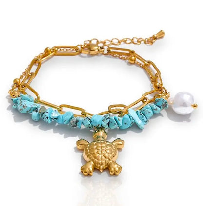 Armband Veda mit türkisfarbenen Steinen und goldener Schildkröte, ideal für einen einzigartigen Look.